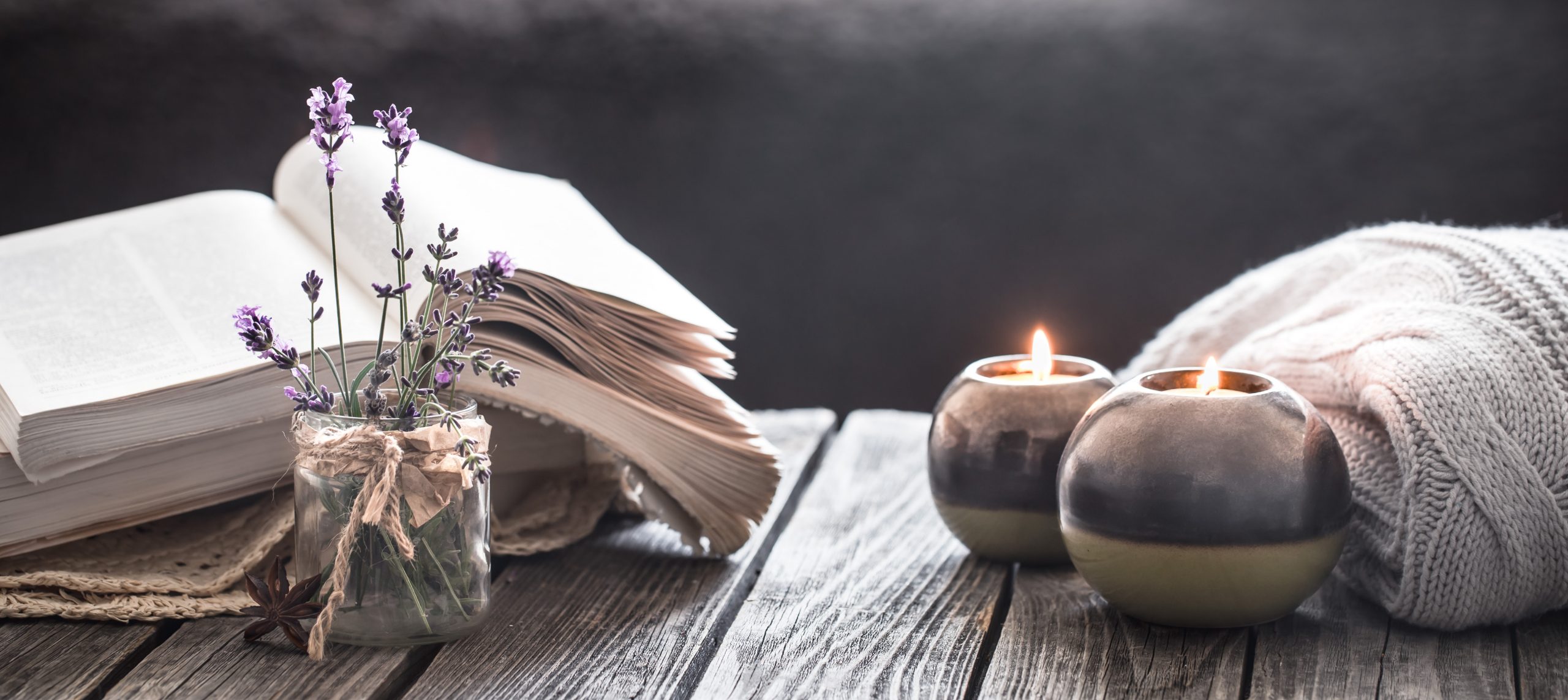 still life a book and a candle on a wooden table